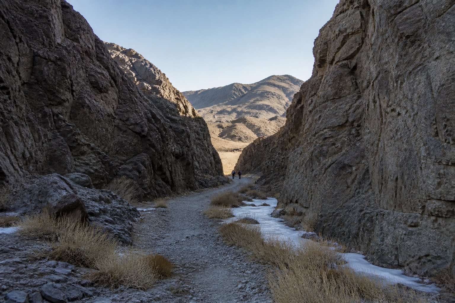 Yolyn Am canyon in the Gobi Desert in Mongolia with travelers in the distance